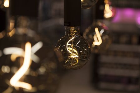 light bulbs hanging from ceiling, abstract image with bokeh backgroundの写真素材