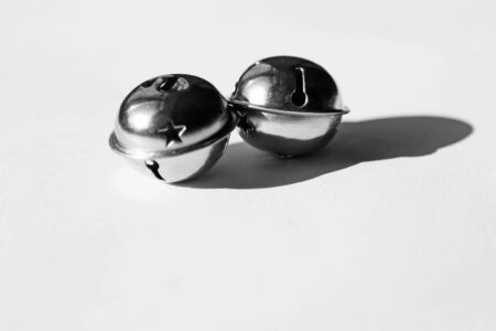 two bells on white background that sound and that you use for Christmas as decorationの写真素材