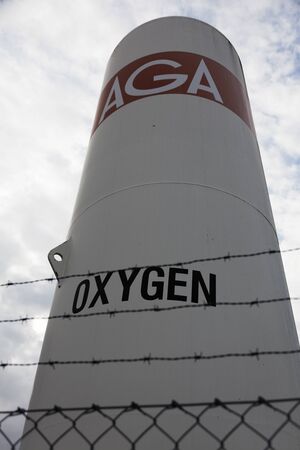 Umea, Sweden - September 6, 2019: large tube with oxygen behind fence with barbed wireのeditorial素材