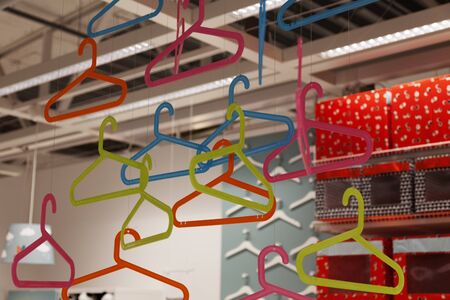 Umea, Sweden - August 31, 2019: lots of clothes hangers hanging from the roof of Ikeaのeditorial素材