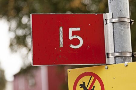 the number fifteen with white text on the red bottom and do not let the dog poop signの写真素材