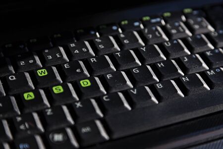plain data keyboard from a laptop computer standing in an office with lots of shadows and lightsのeditorial素材
