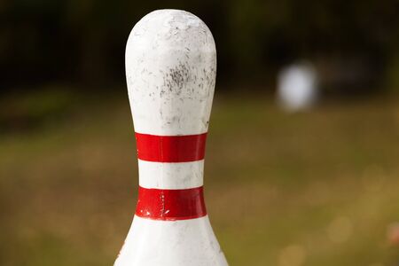 upper part of a bowling pin with blurred green backgroundの写真素材