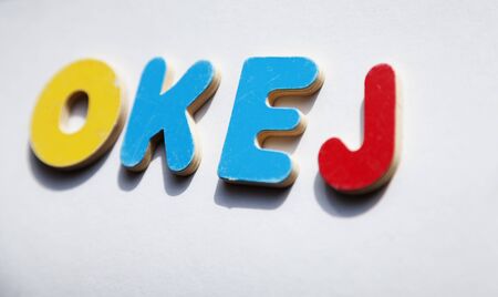the word OKEJ in wooden letters on light surfaceの写真素材
