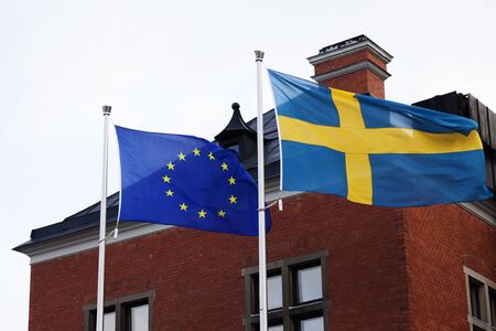 the Swedish and European flag waving in the wind together, the EU summit in progress