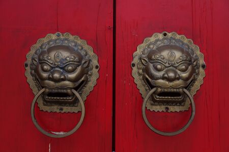Beijing, China - July 8, 2013: detail from red door, two dragon figures as door handleのeditorial素材