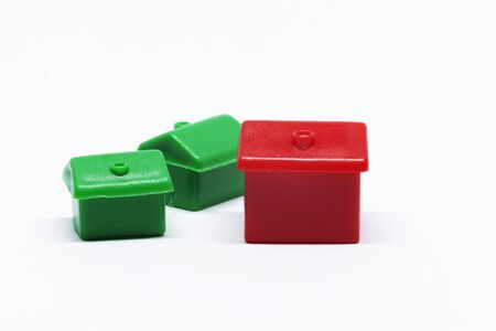 houses and hotels for the game monopoly on white background, symbol of wealth