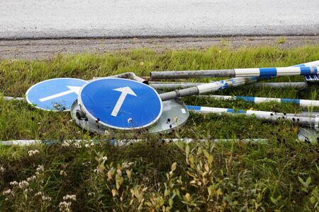 road signs lying down in the grass for mounting
