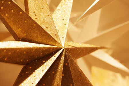 various Christmas stars in gold and cardboard to hang as decoration in the windowsの写真素材