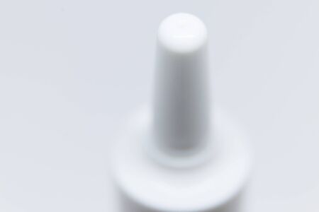 top of bottle with nasal spray on white backgroundの写真素材