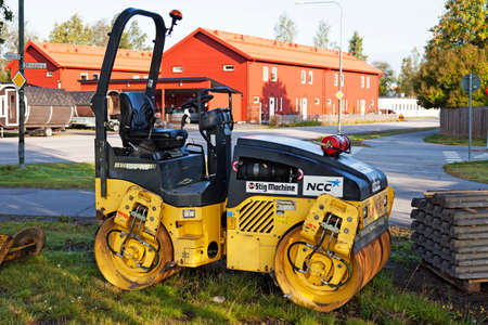 Umea, Norrland Sweden - June 12, 2019: a yellow steam roller parked on a lawn