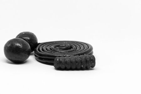 a pile of mixed licorice sweets on white backgroundの写真素材