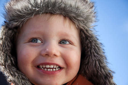Umea, Norrland Sweden - April 6, 2020: a happy boy in fur capのeditorial素材