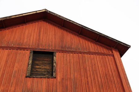 part of an old red swedish wooden house in the museum areaの写真素材