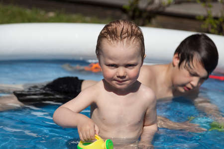 Umea, Norrland Sweden - May 31, 2020: two brothers bathe together in outdoor poolのeditorial素材