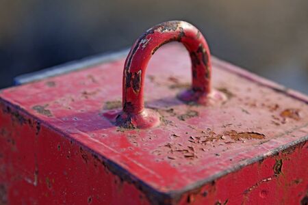 a red very heavy metal weight with handles for the industry