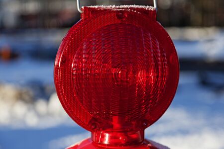 a red warning lamp at road construction in close-upの写真素材