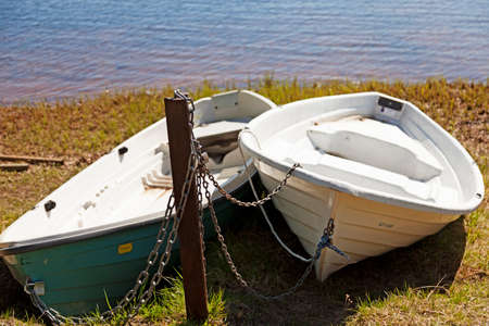 Umea, Norrland Sweden - June 8, 2020: two leisure boats locked with chains on landのeditorial素材