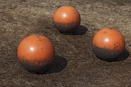 three orange balls at the playground at Hagaの写真素材