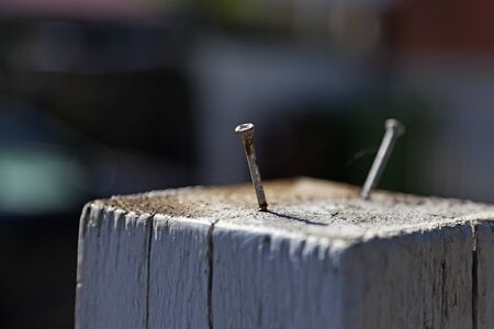 two screws sticking up from a fence on Haga