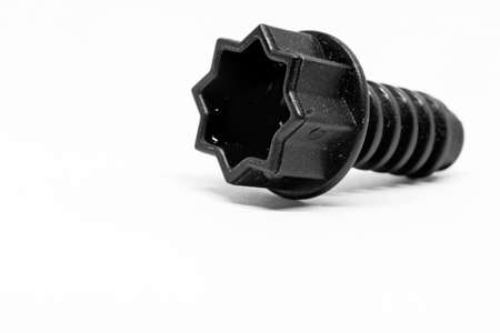 a black plastic screw that requires a star-shaped toolの写真素材
