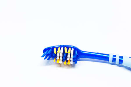 part of a blue toothbrush on white background