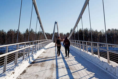 Umea, Norrland Sweden - March 8, 2020: people walk across the new bridge and admire the viewのeditorial素材