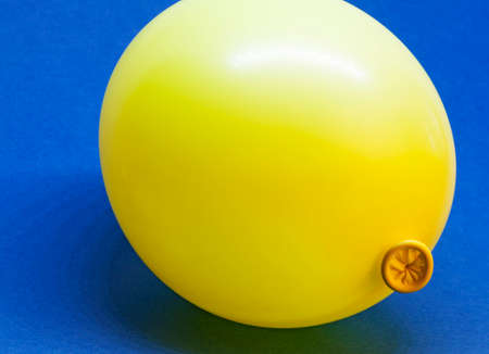a yellow balloon on blue backgroundの写真素材