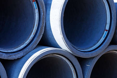 several cement pipes next to each other used in road construction