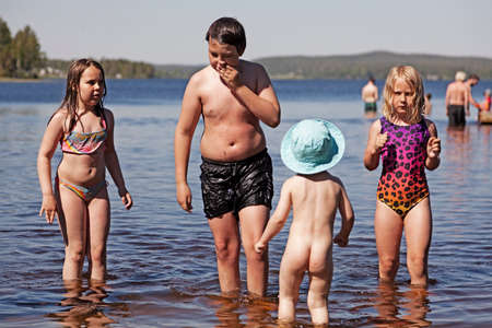 Umea, Norrland Sweden - June 17, 2020: siblings bathe and play together in Yttersjoのeditorial素材