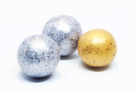edible candy that resembles silver and gold balls