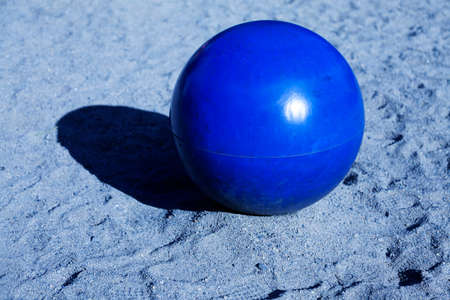 a large metal ball in blue sandの写真素材