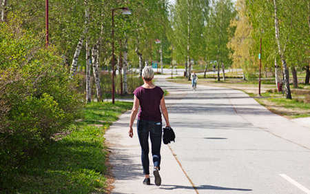 Umea, Norrland Sweden - July 2, 2020: mature woman walking near the universityのeditorial素材