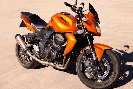 Umea, Norrland Sweden - April 14, 2020: modern orange motorcycle in the desert