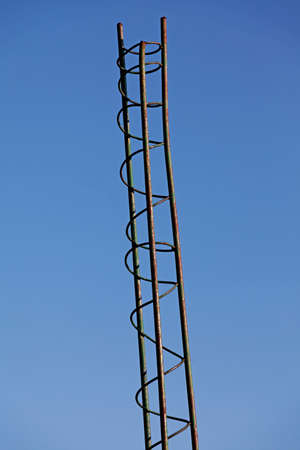 small tower of rebar with reinforcement against blue skyの写真素材