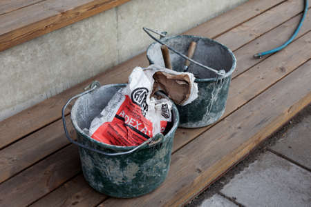 Umea, Norrland Sweden - September 10, 2020: two metal buckets used in masonryのeditorial素材