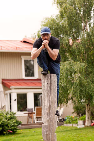 Umea, Norrland Sweden - August 4, 2020: a man is climbing a high pole and prayingのeditorial素材