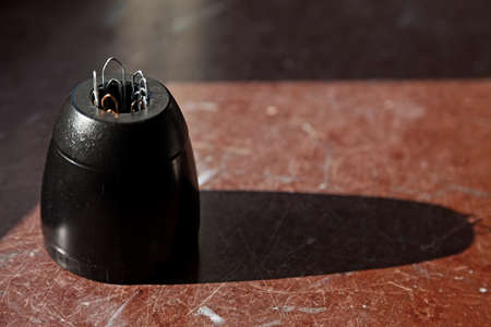 paper clip sticking out of a magnetic jar