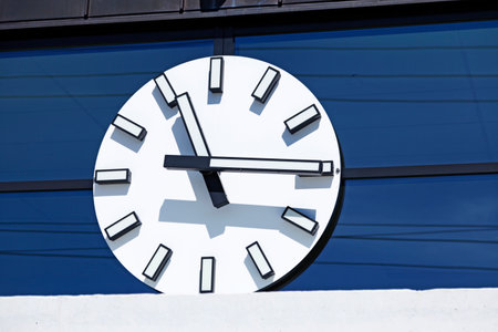 Hornefors, Norrland Sweden - May 10, 2021: a large white clock with hands on station building