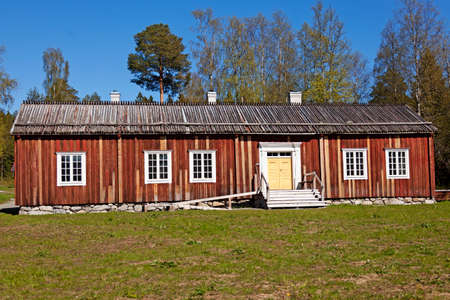 an ancient wooden farmhouse with a low roofの写真素材