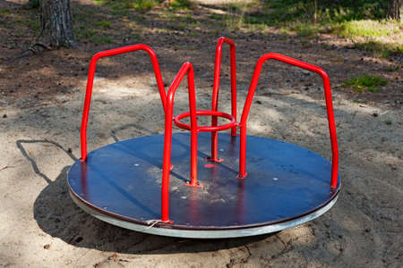 red carousel swing on the playground