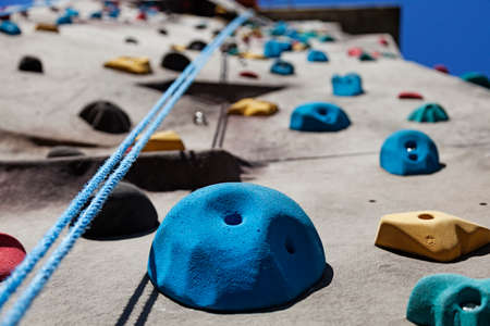 high climbing wall with rope outdoors