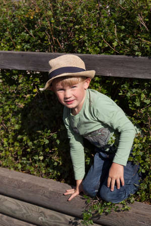 Umea, Norrland Sweden - August 28, 2021: little boy playing and crawling in a garden hedgeのeditorial素材