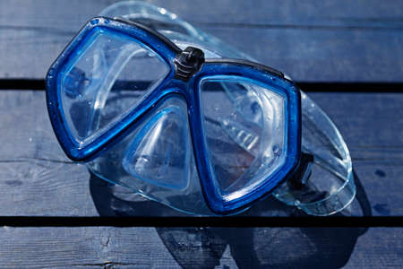 wet diving mask lying and drying in the sunの写真素材