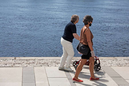 Umea, Norrland Sweden - June 16, 2020: two elderly ladies are out walking by the river during the pandemicのeditorial素材