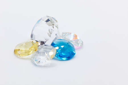 plastic gemstones in different colors on white backgroundの写真素材