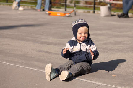 Umea, Norrland Sweden - August 22, 2019: little guy sitting on the ground at skate parkのeditorial素材