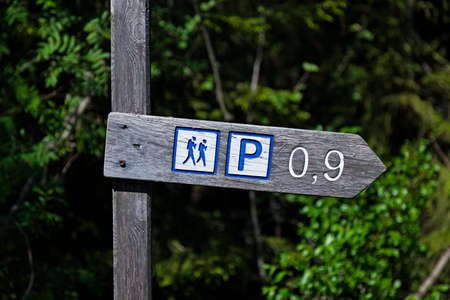 sign with icons for hiking and parkingの写真素材
