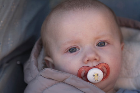 Umea, Norrland Sweden - March 23, 2022: awake little guy with pacifierのeditorial素材