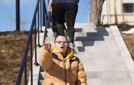 Sundsvall, Norrland Sweden - April 14, 2021: guy with developmental disorder sings from stairs